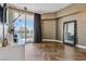 Chic bedroom featuring patterned wallpaper, hardwood floors, and a sliding glass door to a balcony at 2857 Paradise Rd # 2203, Las Vegas, NV 89109