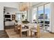 Open-concept dining room with large windows, cityscape views, and a modern chandelier at 2857 Paradise Rd # 2203, Las Vegas, NV 89109