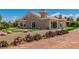The backyard has a well-manicured lawn, desert landscaping, and a putting green at 2937 Billy Casper Dr, Las Vegas, NV 89134