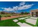Backyard with artificial turf, stone pavers, and golf course views in a desert community at 2937 Billy Casper Dr, Las Vegas, NV 89134