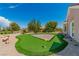 Backyard with putting green with a view of the home under a clear blue sky at 2937 Billy Casper Dr, Las Vegas, NV 89134