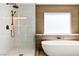 Modern bathroom with soaking tub, frameless shower and designer bronze fixtures at 2937 Billy Casper Dr, Las Vegas, NV 89134