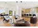 Bright open-concept living area with modern furnishings and seamless flow to kitchen and dining space at 2937 Billy Casper Dr, Las Vegas, NV 89134