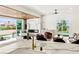 Contemporary living area with fireplace, modern furnishings, and views of the landscaped yard at 2937 Billy Casper Dr, Las Vegas, NV 89134