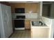 The kitchen has tile floors, black appliances and oak colored cabinets at 3041 Casey Dr # 101, Las Vegas, NV 89120