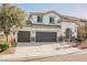 Two-story home with a three-car garage, desert landscaping, and stucco exterior at 3409 Catherine Mermet Ave, North Las Vegas, NV 89081