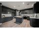 Modern kitchen features gray cabinetry, stainless steel appliances, and center island with white countertops at 3409 Catherine Mermet Ave, North Las Vegas, NV 89081