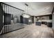 Open-concept living space features modern lighting, wood floors, and view of the kitchen and staircase at 3409 Catherine Mermet Ave, North Las Vegas, NV 89081