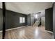 Open living space with wood floors, a window, two doors, and staircase at 3409 Catherine Mermet Ave, North Las Vegas, NV 89081
