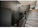 A modern wood staircase with black metal railing leads to the upper level at 3409 Catherine Mermet Ave, North Las Vegas, NV 89081