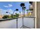 View from the balcony shows palm trees and a street with light traffic at 353 E Bonneville Ave # 181/281, Las Vegas, NV 89101