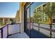 Apartment balcony overlooking city buildings and palm trees reflected in glass doors at 353 E Bonneville Ave # 181/281, Las Vegas, NV 89101