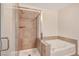 Bathroom featuring a shower and a soaking tub with tiled walls and glass door at 353 E Bonneville Ave # 181/281, Las Vegas, NV 89101