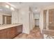 Spacious bathroom featuring double vanity, shower, separate soaking tub, and tiled flooring at 353 E Bonneville Ave # 181/281, Las Vegas, NV 89101