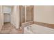 Neutral bathroom with tile flooring, walk-in shower and a soaking tub at 353 E Bonneville Ave # 181/281, Las Vegas, NV 89101