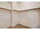 Walk-in closet with neutral walls, carpeted floor, and wood rod for hanging clothes at 353 E Bonneville Ave # 181/281, Las Vegas, NV 89101