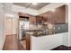 Contemporary kitchen with wood cabinets, stainless steel appliances, granite counters, and tile flooring at 353 E Bonneville Ave # 181/281, Las Vegas, NV 89101