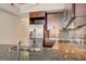 Stylish kitchen features granite counters, stainless steel appliances, tile backsplash, and wood cabinetry at 353 E Bonneville Ave # 181/281, Las Vegas, NV 89101