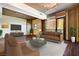 Comfortable living room with hardwood floors, large windows, and modern brown furniture at 353 E Bonneville Ave # 181/281, Las Vegas, NV 89101