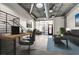 Bright living area features concrete floors, an industrial ceiling, and modern gray furniture at 353 E Bonneville Ave # 181/281, Las Vegas, NV 89101