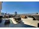 An inviting rooftop patio featuring dining, lounge seating, and stunning views of the city skyline at 353 E Bonneville Ave # 181/281, Las Vegas, NV 89101
