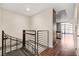 Interior staircase with metal railings leads to a hallway with kitchen and balcony access at 353 E Bonneville Ave # 181/281, Las Vegas, NV 89101