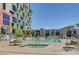 Beautiful community swimming pool and spa, surrounded by landscaping, and residences at 353 E Bonneville Ave # 181/281, Las Vegas, NV 89101