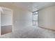 Bedroom with carpeted floors, a large window, and an open doorway at 353 E Bonneville Ave # 503, Las Vegas, NV 89101