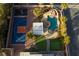 Aerial view of a backyard oasis with a pool, sport court, putting green, and outdoor kitchen at 382 Chaplin Cove Ave, Las Vegas, NV 89183