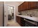 Convenient butler's pantry with sleek countertops, dark wood cabinets, and a built-in wine cooler at 382 Chaplin Cove Ave, Las Vegas, NV 89183