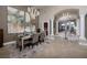 Elegant dining room flows to the foyer and showcases contemporary lighting and large abstract artwork at 382 Chaplin Cove Ave, Las Vegas, NV 89183