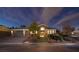 Charming home exterior with a well-manicured lawn and inviting entrance at twilight at 382 Chaplin Cove Ave, Las Vegas, NV 89183