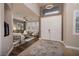 Inviting foyer featuring a patterned rug, double doors, and a view into the cozy living room at 382 Chaplin Cove Ave, Las Vegas, NV 89183