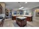 Bright kitchen featuring dark wood cabinets, a marble island and open layout to the living spaces at 382 Chaplin Cove Ave, Las Vegas, NV 89183