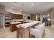 Open kitchen with a large island, stone accents, and stainless steel appliances; perfect for entertaining guests at 382 Chaplin Cove Ave, Las Vegas, NV 89183