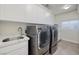 Modern laundry room features gray washer and dryer, sink with marble countertop, and white cabinets at 382 Chaplin Cove Ave, Las Vegas, NV 89183