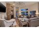 Inviting living room featuring a stone fireplace and large windows providing natural light at 382 Chaplin Cove Ave, Las Vegas, NV 89183