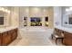 Luxurious bathroom featuring a soaking tub, double sinks, and well lit vanity area at 382 Chaplin Cove Ave, Las Vegas, NV 89183