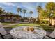 Charming outdoor dining area offers views of the pool, lush backyard, and covered bar at 382 Chaplin Cove Ave, Las Vegas, NV 89183