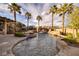 Stunning pool featuring a rock waterfall, spa, and lush tropical landscaping, perfect for outdoor living at 382 Chaplin Cove Ave, Las Vegas, NV 89183