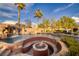 Amazing backyard pool features a rock waterfall and a sunken fire pit with stone accents at 382 Chaplin Cove Ave, Las Vegas, NV 89183