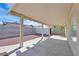 A covered back patio features a concrete slab, privacy wall, small storage shed, and low maintenance desert landscaping at 4137 Buffalo Bill Ave, Las Vegas, NV 89110