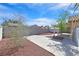 Backyard view features a patio, stone landscaping, block wall, and mature trees at 4137 Buffalo Bill Ave, Las Vegas, NV 89110