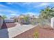 Backyard with a concrete patio, stone landscaping, block wall, and mature trees at 4137 Buffalo Bill Ave, Las Vegas, NV 89110