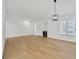 Spacious living room with hardwood floors, fireplace, and modern light fixture at 4137 Buffalo Bill Ave, Las Vegas, NV 89110