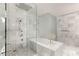 Contemporary bathroom featuring a glass shower enclosure and luxurious soaking tub with marble accents at 4381 W Flamingo Rd # 57306, Las Vegas, NV 89103