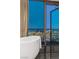 Modern bathroom showcasing a soaking tub next to floor-to-ceiling windows, capturing city views at 4381 W Flamingo Rd # 57306, Las Vegas, NV 89103