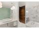Contemporary bathroom featuring double sinks, marble countertops, and a unique vanity at 4381 W Flamingo Rd # 57306, Las Vegas, NV 89103