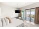 Bright bedroom featuring a lounge area and glass doors opening onto a balcony at 4381 W Flamingo Rd # 57306, Las Vegas, NV 89103