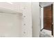 Modern closet with crisp white interiors and a contrasting wood door, offering a clean and organized storage space at 4381 W Flamingo Rd # 57306, Las Vegas, NV 89103